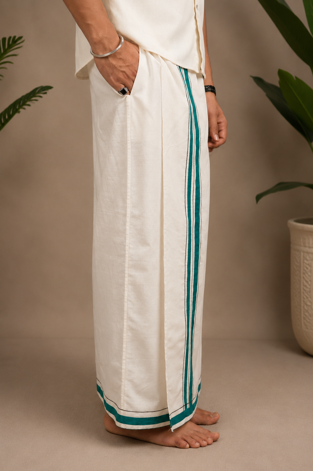 Side view of ivory pomegranate heritage lungi with green stripe